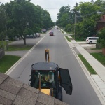 Shed moved across Port Elgin to South End customer. View from the roof of a house being moved up the street.